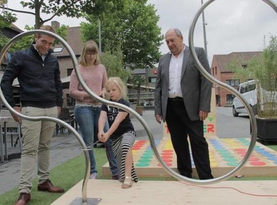 Jeugdschepen Lothar Feys, Liesbeth Theunynck van de jeugddienst en schepen Marc Vanlerberghe kijken hoe een kindje de attracties uittest. - Foto VDI